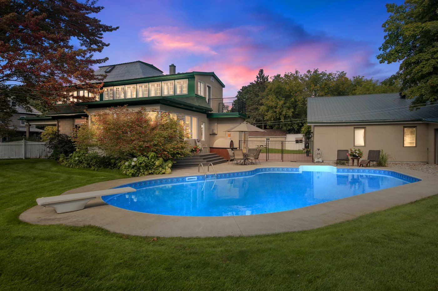 Freeform pool with a fresh finish and deck at dusk